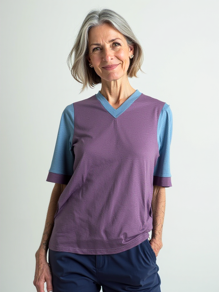 Woman wearing purple and blue adaptive open-back bamboo V-neck top with short sleeves, made in Canada.