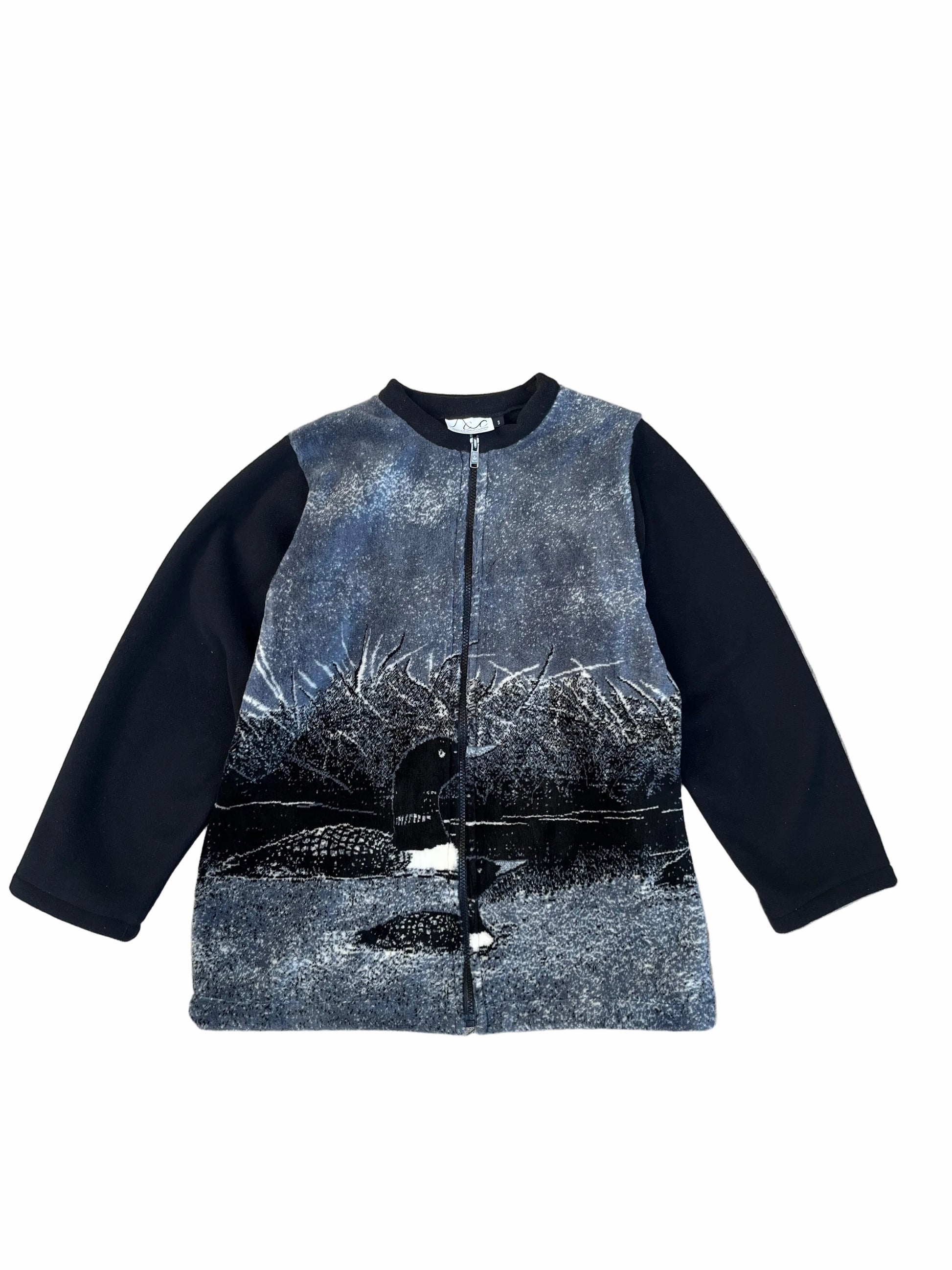 Black and gray patterned jacket on a textured surface